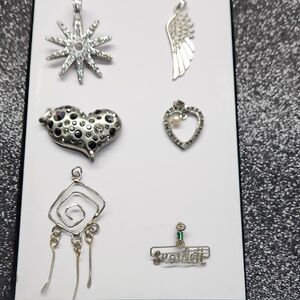 Collection of assorted metal and rhinestone jewelry charms and pendants.